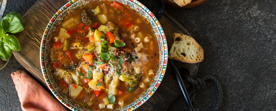 plate with traditional italian vegetable minestrone soup on the table