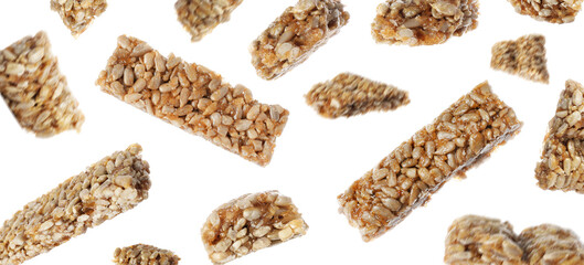 Tasty sweet kozinaki falling on white background, banner design