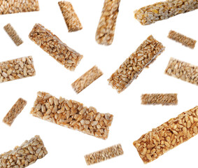 Tasty sweet kozinaki falling on white background