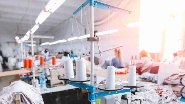 Sewing workshop for disposable gowns for doctors against Covid-19 coronavirus. Concept Interior of garment factory sunlight