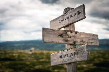 develop a plan text quote written in wooden signpost outdoors in nature. Moody theme feeling.
