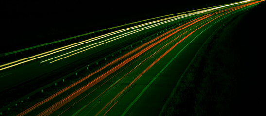 Night road lights. Lights of moving cars at night. long exposure red, blue, green, orange.