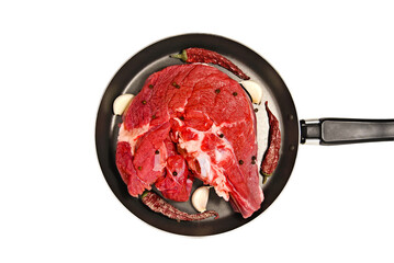A top view of fresh beef meat on the bone with some condiments in the pan isolated on white