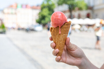 woman hand holding melting ice cream