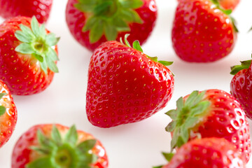 red ripe strawberries on a light background.