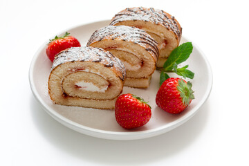 biscuit roll with red ripe strawberries on a light background