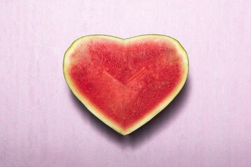 Fototapeta na wymiar Minimal watermelon fruit sweet heart on pink background.