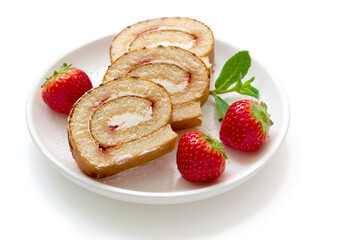 biscuit roll with red ripe strawberries on a light background.
