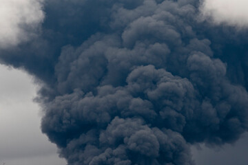 Thick black smoke covers the sky during the war between Ukraine and Russia