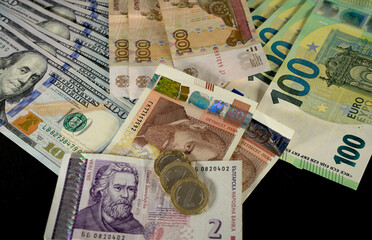 Dollar, ruble, euro and Bulgarian lev banknotes on a black background