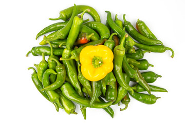 green hot peppers and yellow bell peppers on a white background. vitamin vegetables for health