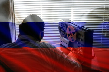 Special agent listens on the reel tape recorder. Russian officer wiretapping in headphones. KGB spying of conversations. - obrazy, fototapety, plakaty