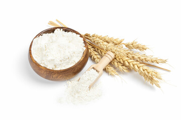 Ripe wheat ears and flour in a wooden bowl on white background