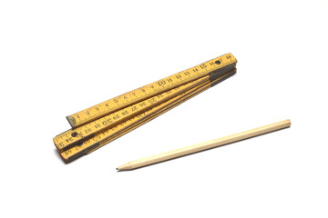 Construction tape measure and pencil on a white background.
