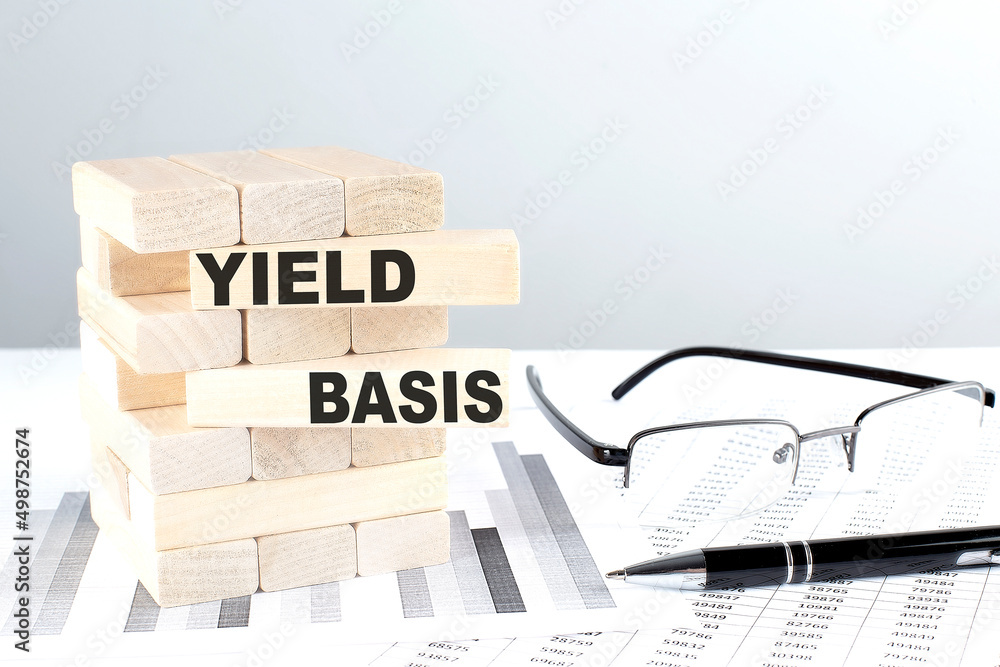 Poster yield basis is written on wooden blocks on a chart background