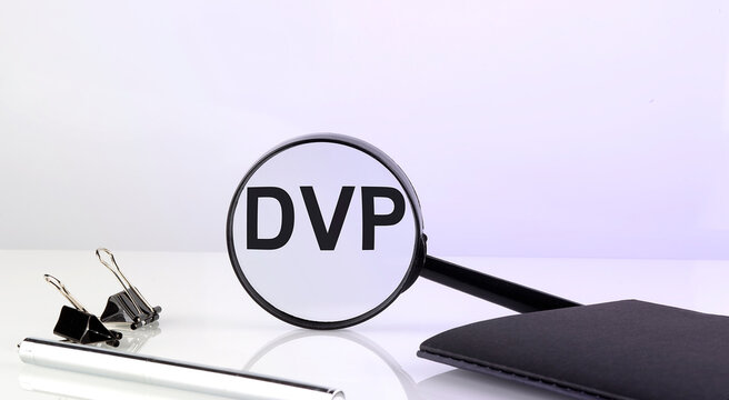 DVP concept. Magnifier glass with text with notebook and pen,business