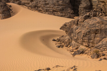 Sand and stones of Hoggar mountains in Sahara desert, Djanet area, Algeria