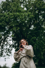 Fototapeta na wymiar Beautiful woman in a white dress. Girl posing in the botanical garden.