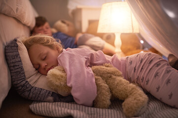 Sleeping tight with sweetdreams. Cropped shot of siblings sleeping under a blanket fort at home.