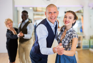 Adult dancing couple enjoying active swing