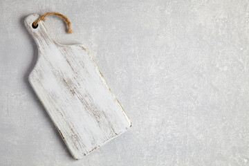 White wooden cutting board on a gray concrete table
