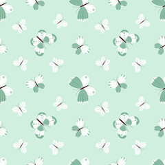 Seamless vector pattern with a variety of butterflies on a light green background.