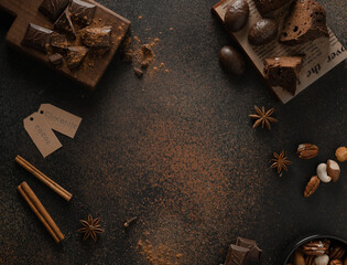 cookies with chocolate pieces and bitter chocolate with cocoa on a dark background, top view. Frame. Copy space