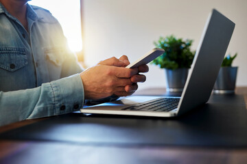 A man writes a message in a communication app on his mobile phone 