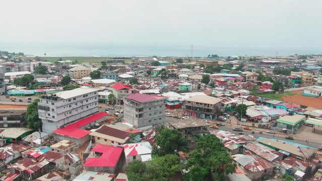 Aerial drone shot of a neighbourhood in Monrovia, Liberia with the Atlantic Coast of West Africa background