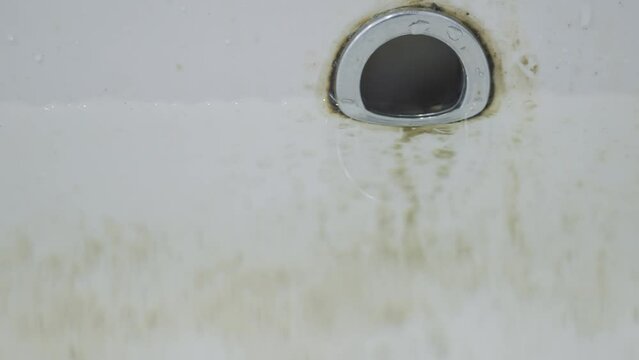 Dirty sink drain or wash mesh hole with rust and grunge from water in the bathroom.