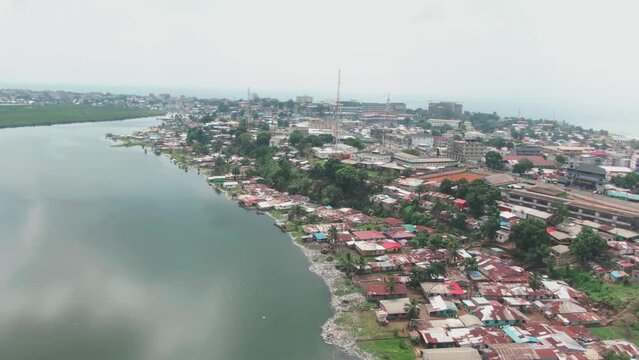 beautiful aerial drone shot of the cityscape of Monrovia, Liberia with the Atlantic Coast of West Africa in the background and Mesurado River in the foreground