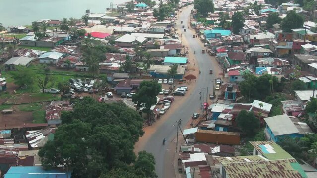 a beautiful street in Monrovia leading along the Mesurado River in Liberia revealing the Monrovia Skyline