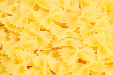 Dry uncooked Italian farfalle pasta close up. 