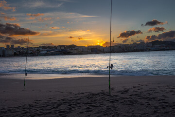 Fishing rods for fishing on the ocean at sunset.