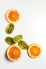 Sliced grapefruit half isolated on white background.  Pink,orange Fresh grapefruit citrus fruit, slice with zest, dramatic light texture, colorful sliced fruits as background back lighted, copy space