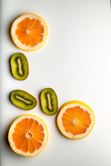 Sliced grapefruit half isolated on white background.  Pink,orange Fresh grapefruit citrus fruit, slice with zest, dramatic light texture, colorful sliced fruits as background back lighted, copy space