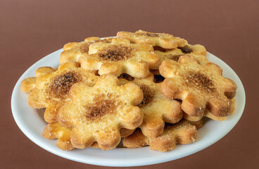 on a plate a bunch of cookies with cinnamon and sugar up close