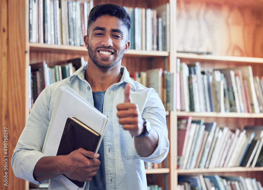 Poster put me to the test and ill be the best. shot of a young man showing thumbs up in a library at univer