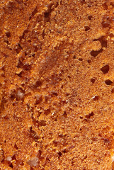 Crust on ruddy cookies as an abstract background.