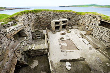 Skara Brae Stone Age Neolithic village at Skaill, Orkney, Scotland. Interior, box beds, hearth and...