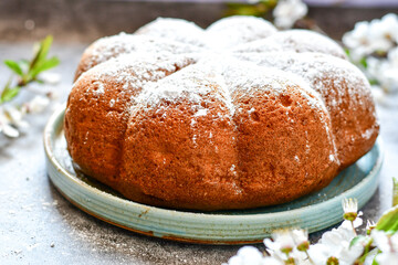 Homemade  Italian style  Easter  bread cake, spring blossom  and  hand colored eggs. Homemade pastry.  Easter holiday baking and decorarion