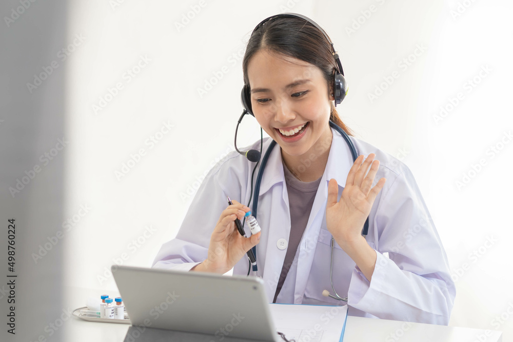 Wall mural Doctor or physician wearing white coat, stethoscope using headset, consulting health by telehealth online for speaking video call consultation on tablet. Telemedicine by medical for distance patient.