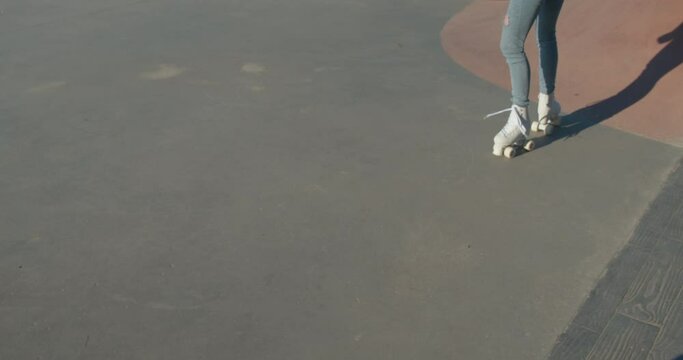 Young woman on white roller blades