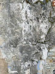 Old distressed wall fragment with scratches and cracks