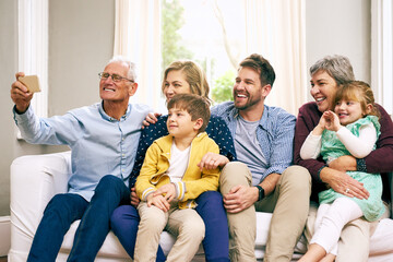 This is our big and beautiful family. Shot of a multigenerational family sitting on the sofa at...