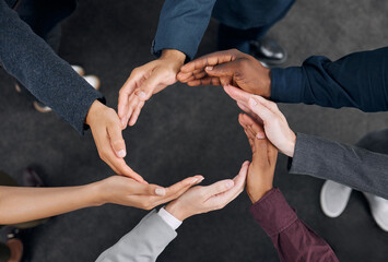 A representation of unity. Shot of a group of businesspeople with their hands joined together to...