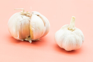 two garlic over on pink background