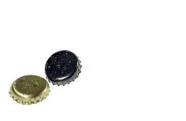 Close up view of metal caps with drops isolated on white background.