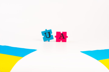Colorful blue-yellow flag of Ukraine and puzzles of letters Ukraine isolated on white. The symbol...