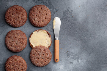 Ruisleipa - traditional Finnish rye bread with butter on a gray concrete